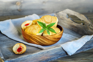 Croissants on a wooden tray. The concept of a wholesome breakfast.