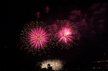 Fototapeta na wymiar Fireworks bursting in city