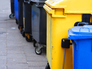 Multicolored trash cans on the street