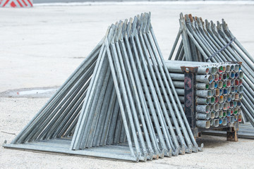 Fototapeta premium Openair storage of galvanized steel and aluminum frames, ladders, and ringlock scaffolding systems for many applications on restoration, industrial and construction sites.