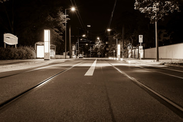 Illuminated Tram Station at Night, Empty Street, Empty Tram Station, Black and White Photo