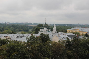 Top view on summer Yaroslavl historical center with church domes and green trees in cloudy day