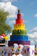 wedding cake in pride colors with a gay couple 