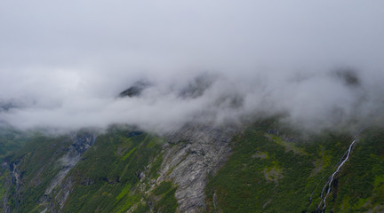 The top part of the famous road Trollstigen in Norway, with beautiful clouds in the background with amazing mountains. July 2019