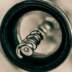 Macro close up of spiral corkscrew bottle opener. Ah-so viewed from the bottom. Monochrome