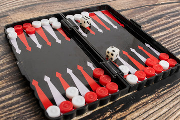 Small pocket backgammon on a wooden table