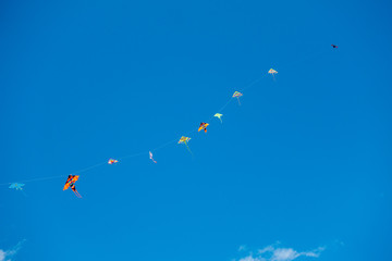 colorful stunt kites flying in the blue sky