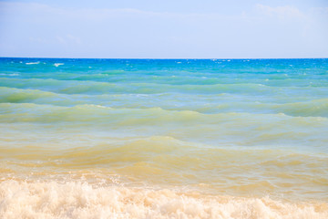 Fototapeta na wymiar Sea waves. Sea of Crimea. High waves in clear weather. Sunny day at sea. Background blue sea waves. Sand beach. Clean beach.