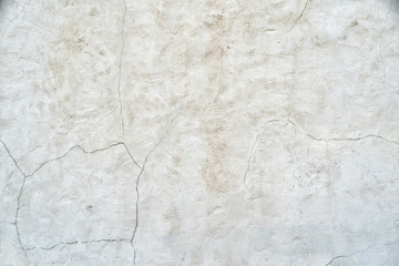 Old gray wall with cracks on the plaster. Abstract background