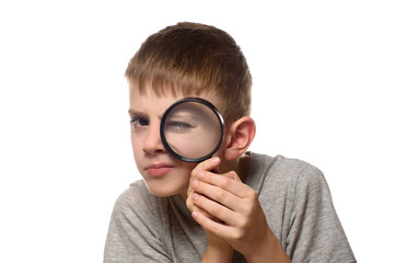 Boy with a magnifying glass in his hands. Little explorer. White background