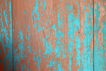 Obraz na płótnie Canvas blue and red peeled wooden wall of the house as a background texture