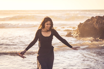 Young girl walking by the coastline enjoying summer traveling