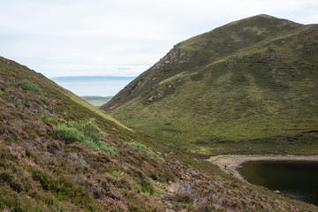 Hills, ocean and beach lake in Isle of Skye, Scotland