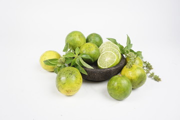 limes on a plate isolated on white background
