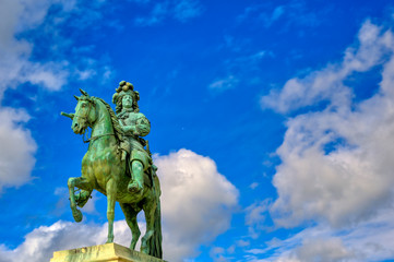 Versailles, France - April 24, 2019: Louis XIV statue just outside of the gates of Versailles Palace on a sunny day outside of Paris, France.
