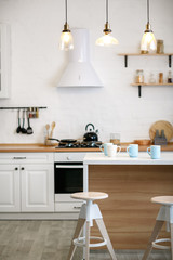 Luxurious white kitchen and living room in a big house