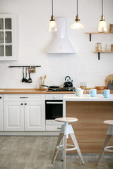 Luxurious white kitchen and living room in a big house
