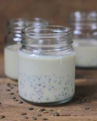black sesame soy milk in glass on wood