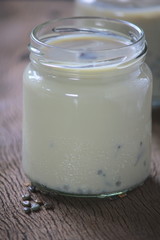 black sesame soy milk in glass on wood