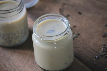 black sesame soy milk in glass on wood