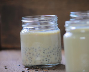 black sesame soy milk in glass on wood