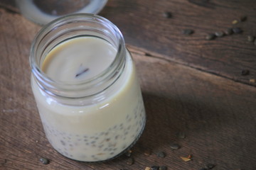 black sesame soy milk in glass on wood