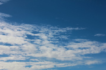 Naklejka na ściany i meble Fantastic soft white clouds against blue sky on background