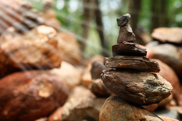 Create balance with meditation rock tower for make meditation peaceful with forest background with daylight 