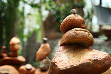 Create balance with meditation rock tower for make meditation peaceful with forest background with daylight 