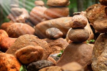 Create balance with meditation rock tower for make meditation peaceful with forest background with daylight 