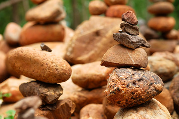 Fototapeta na wymiar Create balance with meditation rock tower for make meditation peaceful with forest background with daylight 