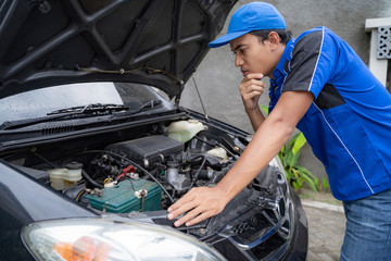 Fototapeta na wymiar home service mechanic doing some inspection on car's engine