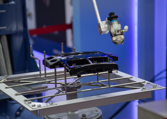 Industry robot painting car parts in automotive industry