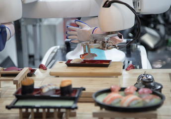 Smart robot preparing japanese food a dish of sushi