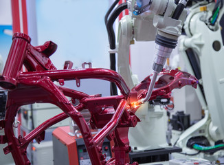 Robot spot welding motorcycle frame in automotive industry