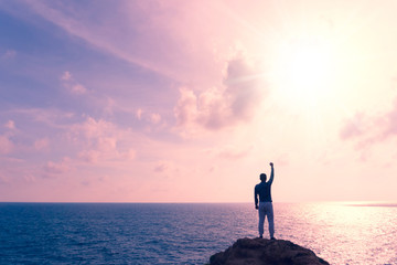 Man rise hands up to sky freedom concept with blue sky and summer beach background.
