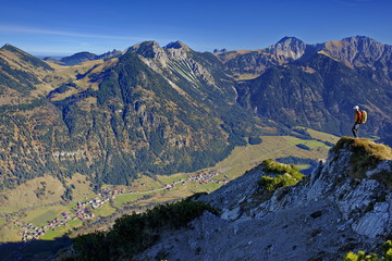 Klettern am Gipfel mit Aussicht auf Berge in den Alpen