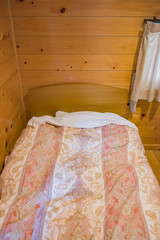 Fototapeta na wymiar Single bed decorate in the wooden bedroom, for new generation alone lifestyle.