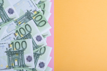 Euro cash on a yellow and pink background. Euro Money Banknotes. Euro Money. Euro bill. Place for text.