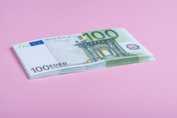 Euro cash on a lilac, purple and pink background. Euro Money Banknotes. Euro Money. Euro bill. Place for text.