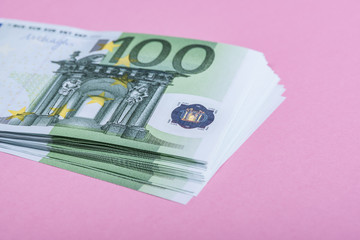 Euro cash on a lilac, purple and pink background. Euro Money Banknotes. Euro Money. Euro bill. Place for text.
