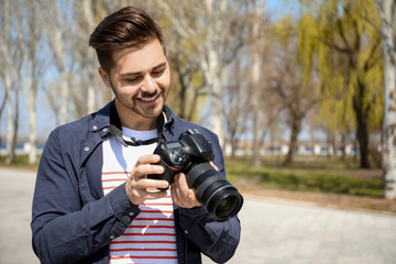 Handsome male photographer outdoors