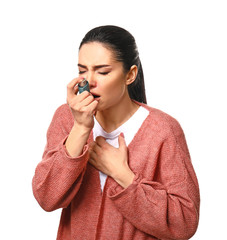 Young woman having asthma attack on white background