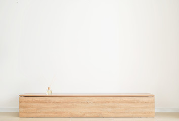 Wooden stand near light wall in room