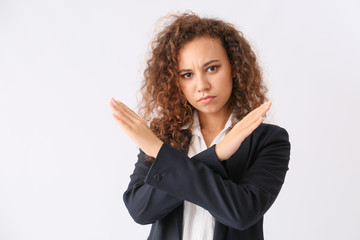 African-American businesswoman rejecting something on white background