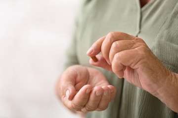 Elderly woman with pill, closeup
