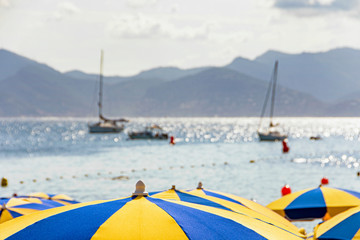 Sea bay with yachts boats and beach umbrella in Cannes