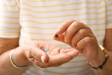 Elderly woman with pills, closeup
