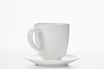 Empty white cup isolated on white