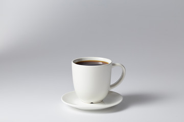 cup of coffee on bright gray background